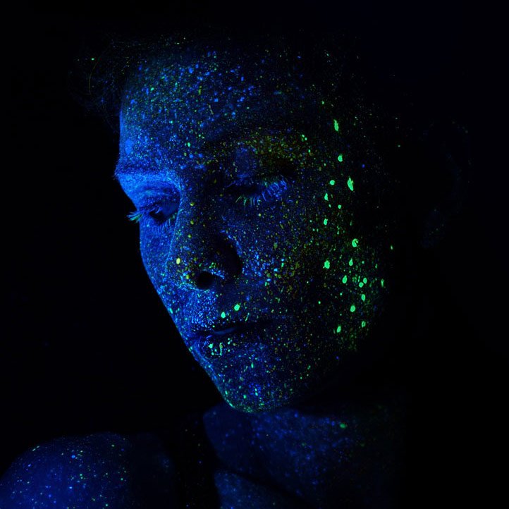 A face in blue UV light